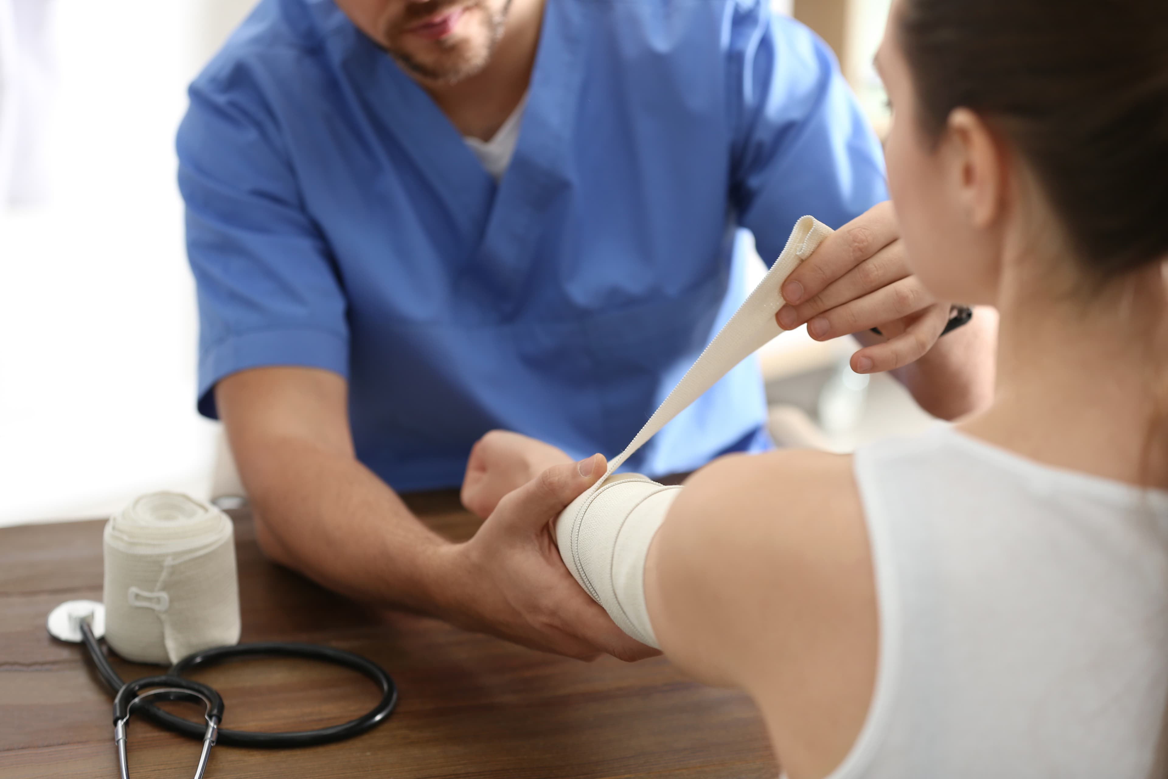 COCN-AP Eligibility Requirements - Wound Care Nursing Review COCN-AP eligibility - clinician wrapping an elastic bandage on a patient arm | Wound Care Nursing Review
