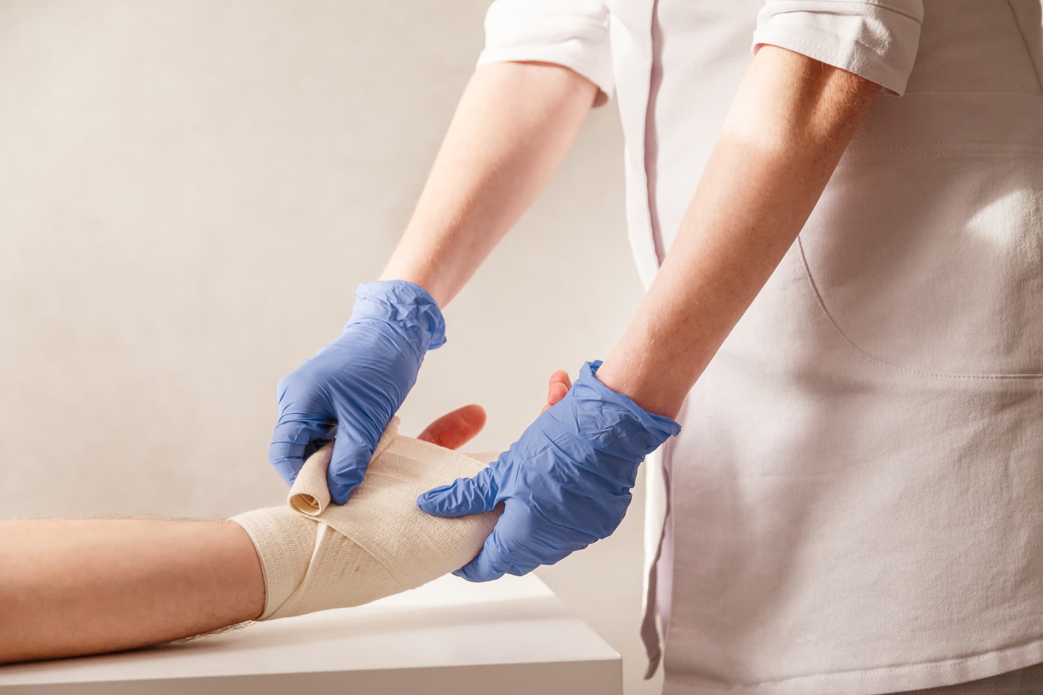 COCN Question Bank - Wound Care Nursing Review COCN question bank - clinician applying bandage during patient care | Wound Care Nursing Review