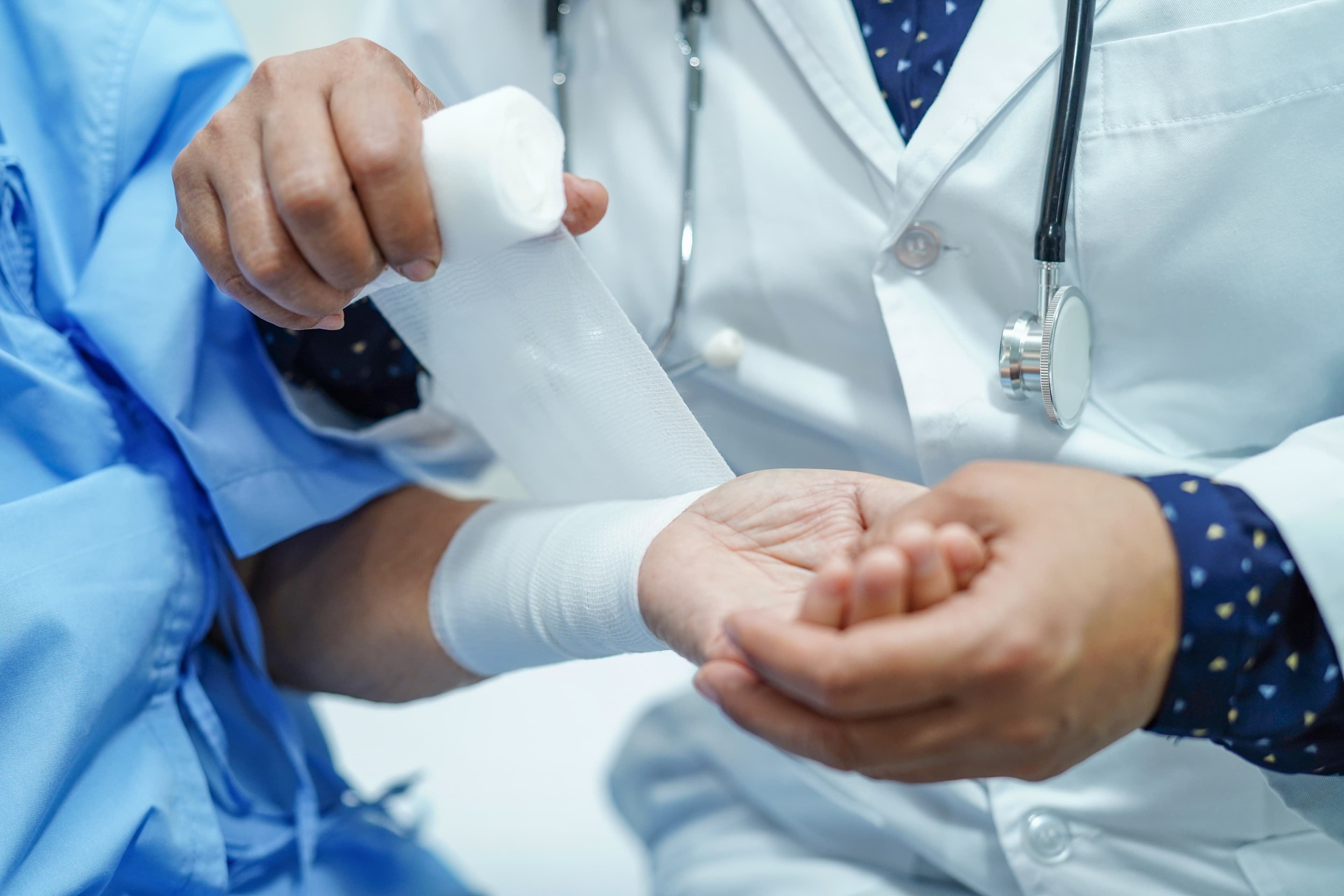 CWCN Exam Prep - Wound Care Nursing Review CWCN exam prep - wound care professional wrapping a patient arm | Wound Care Nursing Review